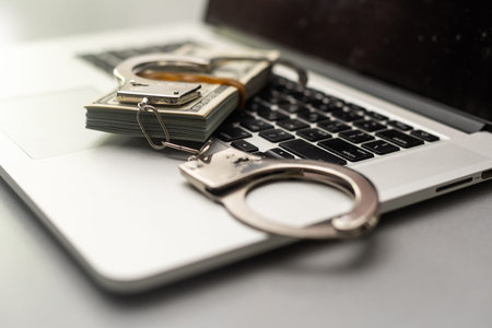 Handcuffs keyboard and dollars aboveの写真素材