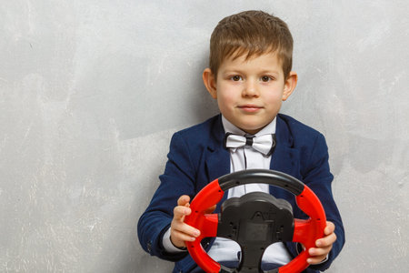 a small schoolboy with a wheel