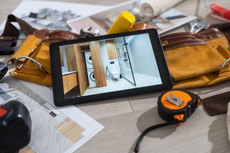 Tablet computer with architecture and construction tools and blueprintsの写真素材