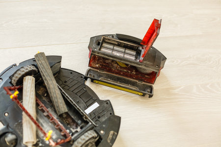 The round robot vacuum cleaner collapsed on the floor. The vacuum cleaner washer is broken. Repair...