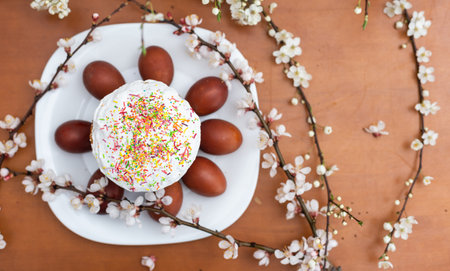 Colorful Easter eggs with spring blossom flowers. Colored Egg Holiday border. Easter cakeの写真素材