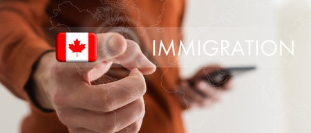 Man pointing at word IMMIGRATION and world map on dark blue background, closeup.の写真素材