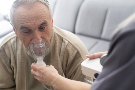 Elderly Senior Man nursing care wear oxygen inhaler device for helping breath respiratory. Oxygen Concentrator portableの写真素材
