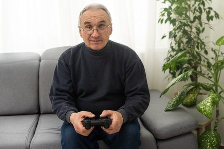 Portrait of elderly man playing video games