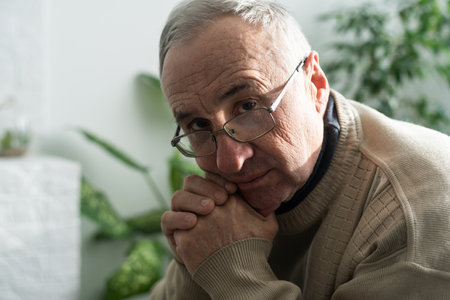 old age, problem and people concept - close up of senior man in glasses thinking.の写真素材