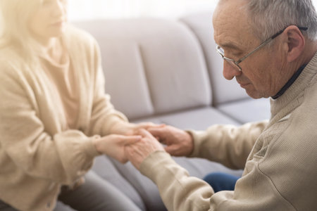 Senior couple, happy and laughing in their home with love, care and support for retirement lifestyle. Commitment of a funny man and woman in a marriage with trust and security on a living room couch.の写真素材