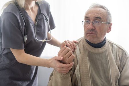 Portrait of mature female psychiatrist interviewing handicapped senior man during therapy session, copy space.の写真素材