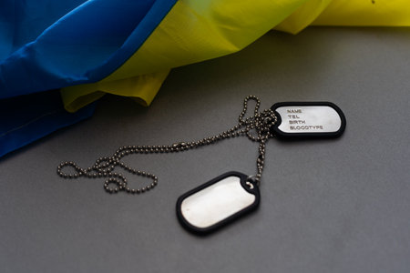 military ID tag and Ukrainian flag on background. Banner designの写真素材