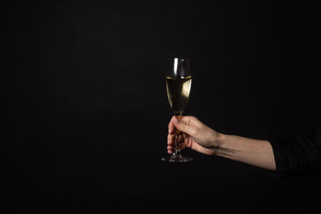glass of champagne on black background