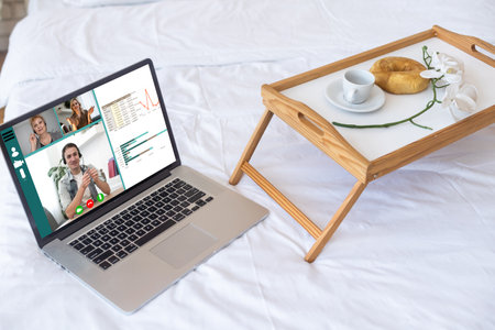 Video conference by laptop. On the laptop screen, colleagues who gathered in a video conference to work on-line. The laptop is at home.の写真素材