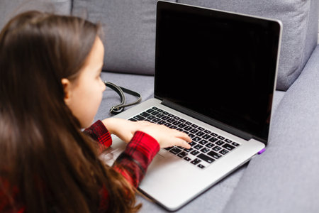 Happy little girl buying online at home, shopping onlineの写真素材