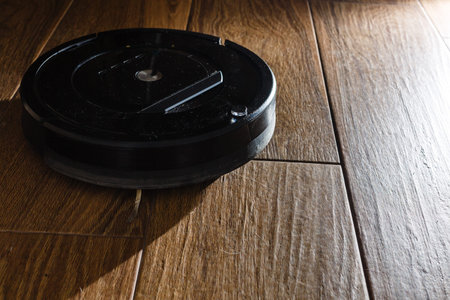 Robotic vacuum cleaner on laminate wood floor smart cleaning technology