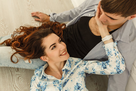 Couple lying on the floorの写真素材