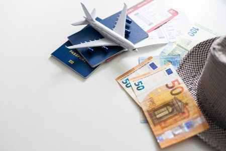 Toy airplane and passport with tickets on white background, top viewの写真素材