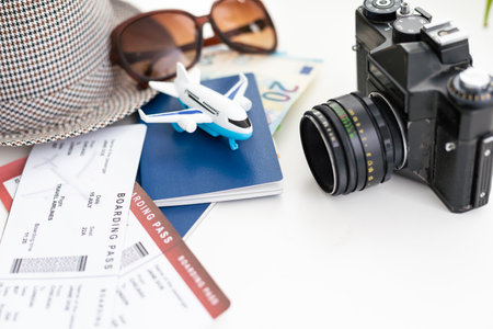 tourist stuff with passport and hat on white background top view.の写真素材