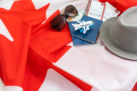 Flag of Canada with passport and toy airplane. Flight travel conceptの写真素材