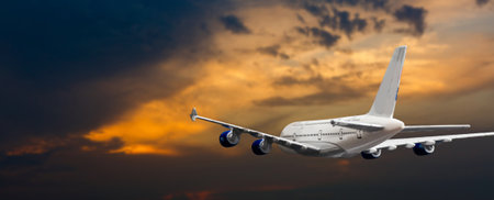 Commercial airplane flying above clouds in dramatic sunset light. Very high resolution of image.の写真素材