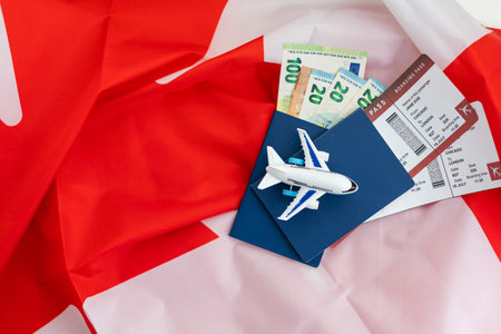 Flag of Canada with passport and toy airplaneの写真素材