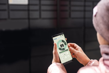 girl touch the button in the app at smartphone for opening box in modern postal automat....