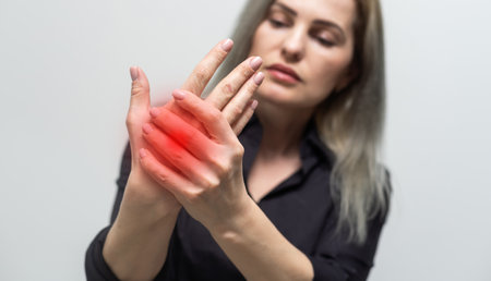 Wrist pain. Painful hand with red spot closeup. Sprain, fracture. Arthritis, office syndrome. Health care, medicine concept.の写真素材