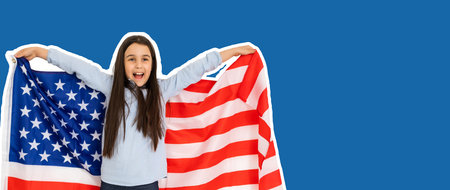 child with american flag on a blue backgroundの写真素材