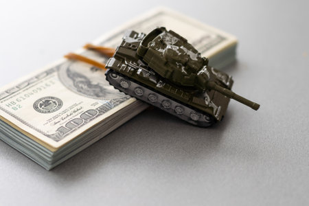 toy tank on the background of dollar billsの写真素材