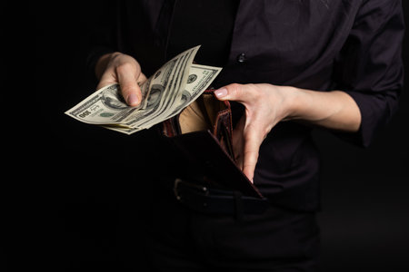 Successful beautiful business young woman holding money US dollar bills in hand, business conceptの写真素材