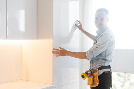 kitchen installation. Worker assembling furniture.の写真素材