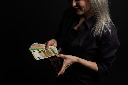 young woman holding euro billsの写真素材