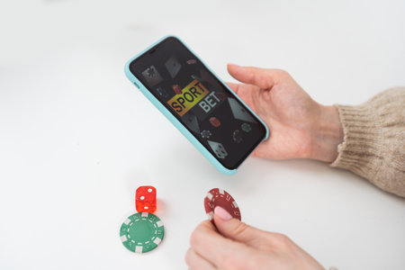 woman holding smartphone betting. online sport gambling application on her mobile phone.の写真素材