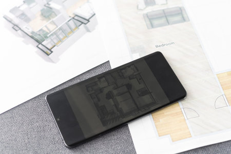 website wireframe sketch and programming code on smartphone