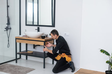 plumber service. Plumber portrait near wash basin siphon installationの写真素材