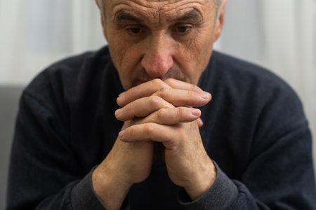 Elderly caucasian man with interlocked fingersの写真素材