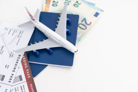 Travel accessories on the light boards. Hat, camera, document holder with passport, glassesの写真素材