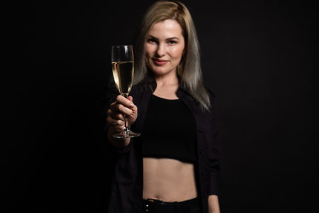 woman with a glass on a black backgroundの写真素材