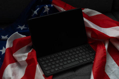 Tablet pc computer on american flag, technology, patriotism, anniversary, national holidays and independence day.の写真素材