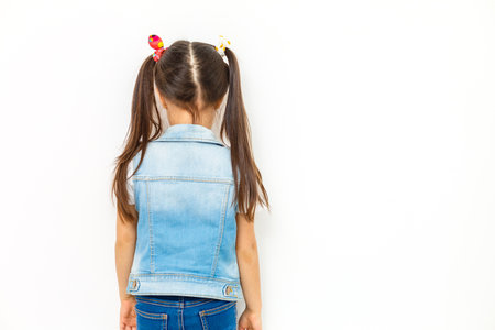 The little girl costs a back to the spectatorの写真素材