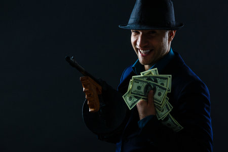 Man taking dollars banknotes with stealthy expression against grunge backgroundの写真素材