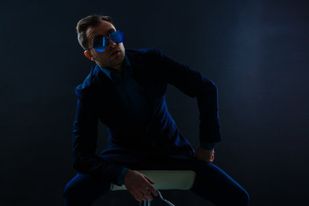 businessmen modern style suit fashion sunglasses dark background.の写真素材