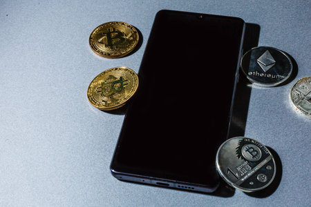 bitcoin to phone. bitcoin and shiny gold barsの写真素材