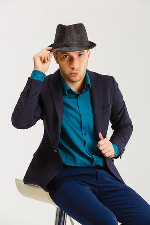 Confident middle-aged wealthy man dressed in retro style suit with hatの写真素材