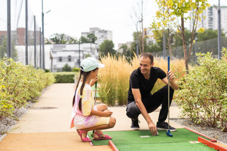 Family: Family Time Playing Mini-Golf In The Summer.の写真素材