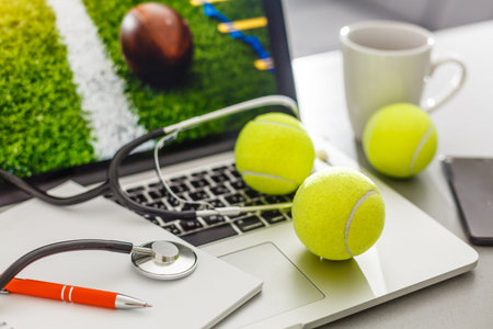 laptop with stethoscope and tennisの写真素材