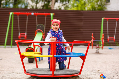 Active little girl playing on a playgroundの写真素材