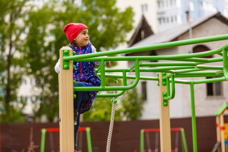 Active little girl playing on a playground