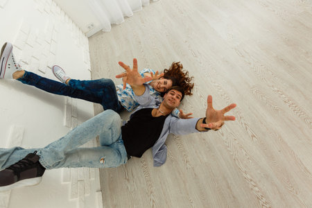 Couple lying on the floorの写真素材