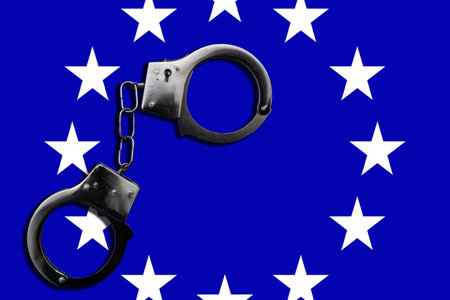 FreedomHandcuff on the flag of European Union. Flag of European Union and handcuffs, European Union law concept. Closeup, copy space for text.の写真素材