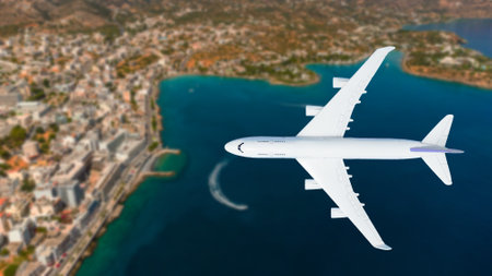 Airplane flying over beach with palm tree, white sand and turquoise oceanの写真素材