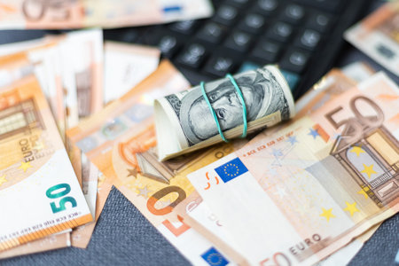 200 Euro banknote next to 50 euros on top of one hundred dollar bills. Trading Euro with Dollar.の写真素材