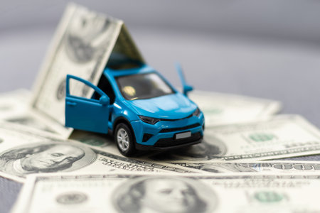 flat lay toy car, toy house, keys and money on the tableの写真素材